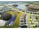An aerial view of a neighborhood showcases the community ponds and manicured landscaping at 16126 Sunday Stroll Way, Odessa, FL 33556