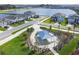 Aerial view of picnic shelter surrounded by landscaping and walking path near a lake at 16126 Sunday Stroll Way, Odessa, FL 33556