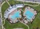 Overhead aerial view showcasing the dual swimming pools and meticulously landscaped grounds of the community at 16126 Sunday Stroll Way, Odessa, FL 33556