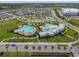 Beautiful aerial view of community pools, clubhouse, and recreational areas amidst lush landscaping at 16126 Sunday Stroll Way, Odessa, FL 33556
