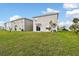 This backyard features a spacious green lawn ideal for outdoor activities and relaxation at 16126 Sunday Stroll Way, Odessa, FL 33556