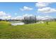 Lovely backyard features pond and community view for relaxing and serene outdoor living at 16126 Sunday Stroll Way, Odessa, FL 33556