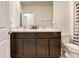 Bathroom featuring double sinks, a granite countertop, and wooden cabinetry at 16126 Sunday Stroll Way, Odessa, FL 33556