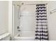 Bright bathroom featuring a shower/tub combo with a striped curtain at 16126 Sunday Stroll Way, Odessa, FL 33556