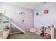 bedroom with bunkbed slide, playful wall art, and a cozy unicorn themed reading corner at 16126 Sunday Stroll Way, Odessa, FL 33556
