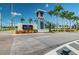 Elegant community entrance featuring a blue lighthouse style tower, attractive landscaping, and signage at 16126 Sunday Stroll Way, Odessa, FL 33556