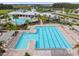 Community pool with a separate area for lap swimming, lounge chairs, and umbrellas at 16126 Sunday Stroll Way, Odessa, FL 33556