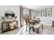 Dining area with a wood table and chairs next to a sliding glass door at 16126 Sunday Stroll Way, Odessa, FL 33556