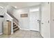 Inviting entryway with tiled floor, staircase, front door with transom window, and decorative wall art at 16126 Sunday Stroll Way, Odessa, FL 33556