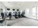 Community fitness center with a variety of modern cardio machines, televisions, and exercise equipment for residents' use at 16126 Sunday Stroll Way, Odessa, FL 33556