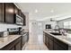 Modern kitchen featuring stainless steel appliances and granite countertops at 16126 Sunday Stroll Way, Odessa, FL 33556