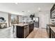 Open kitchen with stainless steel appliances, a granite island, and tile flooring at 16126 Sunday Stroll Way, Odessa, FL 33556