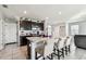 Bright kitchen features granite counters, stainless appliances, and a center island with seating at 16126 Sunday Stroll Way, Odessa, FL 33556