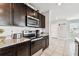 Modern kitchen featuring stainless steel appliances and granite countertops at 16126 Sunday Stroll Way, Odessa, FL 33556