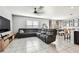 Spacious living room featuring modern tile flooring, large windows, and a comfortable sectional sofa at 16126 Sunday Stroll Way, Odessa, FL 33556