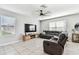 Cozy living room with a large television, comfortable seating, and ample natural light at 16126 Sunday Stroll Way, Odessa, FL 33556