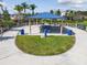 A shaded picnic shelter with tables, seating and trash receptacles set in a landscaped green space at 16126 Sunday Stroll Way, Odessa, FL 33556