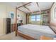 Bedroom with a four-poster bed, shelving and natural light at 1868 Shore S Dr # 602, South Pasadena, FL 33707