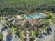 Aerial view of the community clubhouse featuring a resort-style pool, palm trees, and lush landscaping at 20115 Nob Oak Ave, Tampa, FL 33647