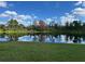 Picturesque view of the lush backyard landscaping and serene lake at 20115 Nob Oak Ave, Tampa, FL 33647