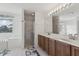Bathroom featuring a double sink vanity with tiled shower and separate soaking tub next to the window at 20115 Nob Oak Ave, Tampa, FL 33647