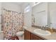 Bathroom with a shower/tub combo and floral shower curtain at 20115 Nob Oak Ave, Tampa, FL 33647