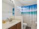 Bathroom featuring a vanity, mirror, and shower with a stylish ocean-themed curtain at 20115 Nob Oak Ave, Tampa, FL 33647