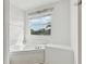 Bright bathroom features a soaking tub beneath a window at 20115 Nob Oak Ave, Tampa, FL 33647