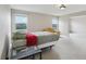 Spacious bedroom with a bed, yellow sofa, and views from the windows at 20115 Nob Oak Ave, Tampa, FL 33647