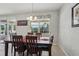 Formal dining room features a modern chandelier, view of the outdoor pool, and a six-chair dining set at 20115 Nob Oak Ave, Tampa, FL 33647