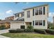 Charming two-story home showcasing manicured landscaping, a two-car garage, and decorative shutters at 20115 Nob Oak Ave, Tampa, FL 33647
