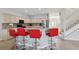 Bright kitchen featuring bar seating, stainless appliances, and convenient access to the stairs and front entrance at 20115 Nob Oak Ave, Tampa, FL 33647