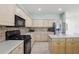 Bright kitchen with a center island, stainless steel refrigerator, and tile backsplash at 20115 Nob Oak Ave, Tampa, FL 33647