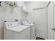 Convenient laundry room with washer and dryer hookups, storage shelves, and a utility sink at 20115 Nob Oak Ave, Tampa, FL 33647