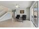 Open living area with neutral tile, ceiling fan, and sliding glass doors to the lanai at 20115 Nob Oak Ave, Tampa, FL 33647