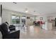 Spacious living room flows to dining area with a view of the pool and pond at 20115 Nob Oak Ave, Tampa, FL 33647
