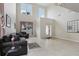 Open-concept living room featuring tile flooring, high ceilings and large windows at 20115 Nob Oak Ave, Tampa, FL 33647