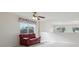 Cozy loft area with bright windows, a red sofa, and neutral paint at 20115 Nob Oak Ave, Tampa, FL 33647