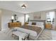 Primary bedroom with a large bed, nightstands, dresser and a bench at 20115 Nob Oak Ave, Tampa, FL 33647