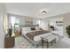 Primary bedroom with a large bed, nightstands, dresser and a bench at 20115 Nob Oak Ave, Tampa, FL 33647