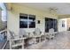 Covered outdoor patio with comfortable seating area and ceiling fan at 20115 Nob Oak Ave, Tampa, FL 33647