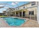 Screened-in pool with brick trim and safety fence, perfect for relaxation and outdoor enjoyment at 20115 Nob Oak Ave, Tampa, FL 33647