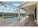 Beautiful screened-in pool area with brick pavers and a scenic view of the lush backyard and pond at 20115 Nob Oak Ave, Tampa, FL 33647