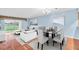 Bright living room features modern decor, large windows, and stylish dining area at 204 Mary Dr, Oldsmar, FL 34677