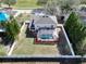 Aerial view showcasing the back of the home, screen enclosed pool, and a spacious, fenced-in backyard at 2108 Valrico Heights Blvd, Valrico, FL 33594