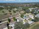 Wide aerial shot showcasing the neighborhood homes and a sprawling green field beyond the backyard fences at 2108 Valrico Heights Blvd, Valrico, FL 33594