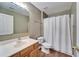 Bathroom with sink, toilet, and tub with a curtain at 2108 Valrico Heights Blvd, Valrico, FL 33594