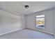 Bright bedroom featuring gray walls, neutral carpet, and a view of the neighborhood at 2108 Valrico Heights Blvd, Valrico, FL 33594