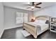 Bedroom featuring a ceiling fan, a large window, and a light wood bed frame at 2108 Valrico Heights Blvd, Valrico, FL 33594