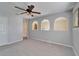 Bedroom featuring three archways, a ceiling fan and a closet door at 2108 Valrico Heights Blvd, Valrico, FL 33594